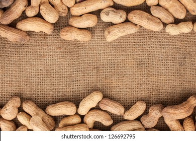 unpeeled peanuts lying on burlap can be used as background