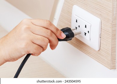 Unplug or plugged in concept,hand holding and pull electric plug 