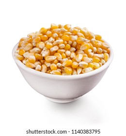 Unpopped popcorn seeds in ceramic bowl, isolated on white background.