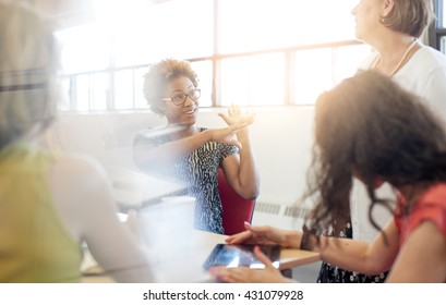 Unposed Group Of Creative Business People In An Open Concept Office Brainstorming Their Next Project.