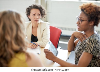 Unposed Group Of Creative Business People In An Open Concept Office Brainstorming Their Next Project.