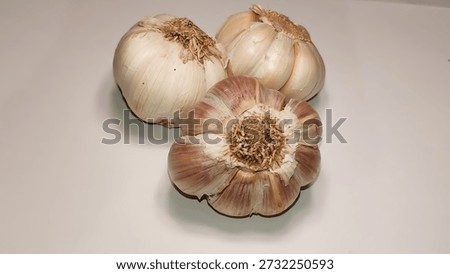 unprocessed garlic with a clean white background