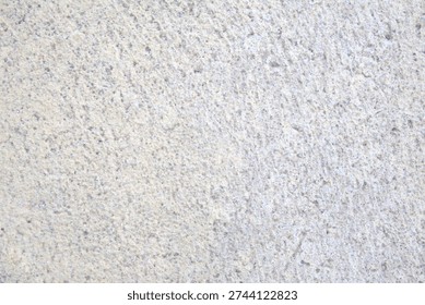 The unprocessed marble block surface, sourced from Türkiye's Denizli region, stands out with its natural grey texture and subtle irregularities. The minimalist background reflects Anatolian stone heritage, material documentation, and rustic aesthetics. Rough marble surface. Grey, empty, abstract background for designs.