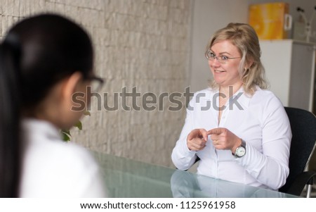 Similar – Female doctor talking to elderly patient in wheelchair