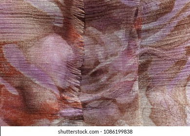 Unraveling Edge Of Thin Brown And Mauve Chiffon Fabric