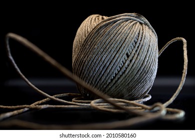 Unravelling Ball Of Household Yarn Black Background