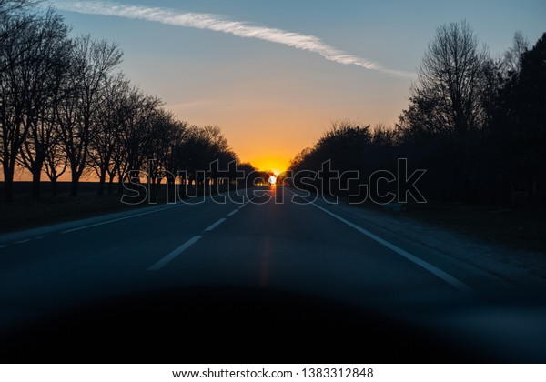 Unreal sunset on road\
from inside of car.