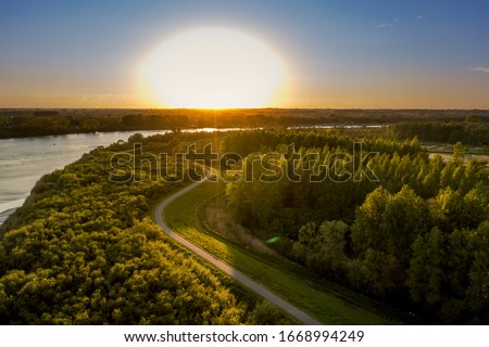 Unrealistic sunset over the Scheldt river, in Bornem, Belgium