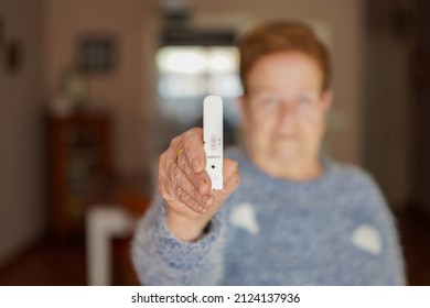 Unrecognisable Elderly Woman Shows The Positive Result Of A Covid 19 Serology Test On The Screen.