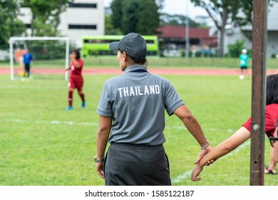 Unrecognisable female soccer coach holds hand of football girl player - Powered by Shutterstock