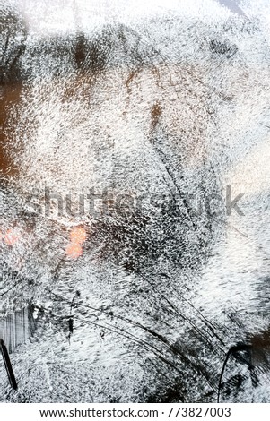 Unrecognised scratch marks on glass whitewash creating an abstract pattern