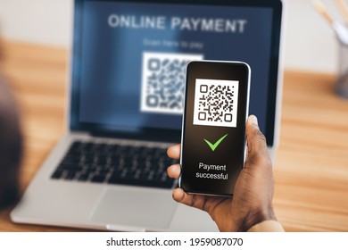 Unrecognizable afican american man scanning qr code from laptop with smartphone, closeup. Black man hand holding mobile phone in front of qr code on screen. Payment systems concept, collage