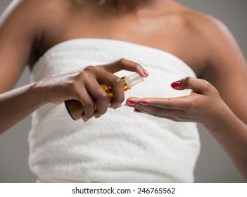 Unrecognizable african woman applying cream . Skincare concept