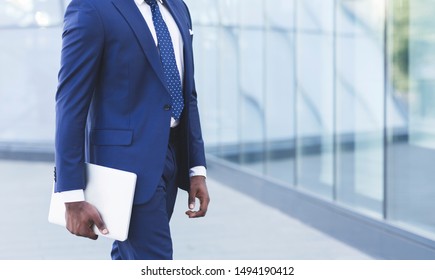 Unrecognizable Afro Business Guy Carrying Laptop Computer Going To Work In City. Cropped, Empty Space For Text