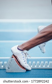 Unrecognizable Afro Sportswoman In Sportswear Beginning Race From Crouch Start Position On Starting Blocks