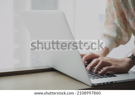 Unrecognizable Asian young woman using laptop computer or notebook computer to search the news and information in the internet with searching box tools interface.