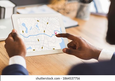 Unrecognizable Black Businessman Using Taxi Services App On Digital Tablet In Office, Looking At Virtual Map With GPS Trackers, Checking Nearest Cab, Creative Collage For Transportration Concept