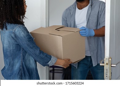 Unrecognizable Black Delivery Man Delivering Package To Woman Homeowner, Giving Cardboard Box With Her Order, Cropped Image