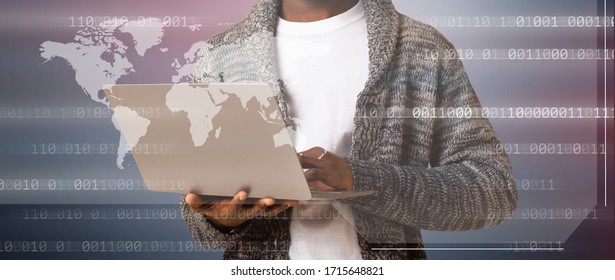 Unrecognizable black hacker holding laptop with virtual display server data, binary code and world map over dark background, panorama - Powered by Shutterstock - Get 15% off with code: PIKWIZARD15