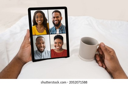 Unrecognizable Black Man In Bed Drink Coffee, Have Video Call With Family Or Friends, Headshot Of Different People On Tablet Screen, Pov, Close Up. App, Communication, Online Meeting At Home, Collage