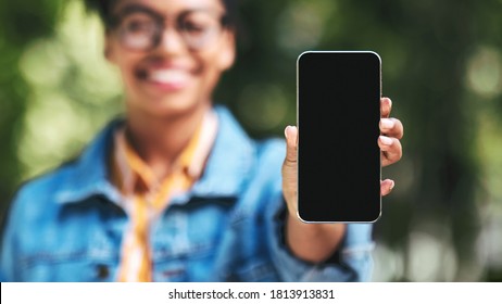 Unrecognizable Black Woman Showing Cellphone Empty Screen Recommending Application Standing Outdside. Shallow Depth, Mockup, Panorama