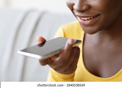 Unrecognizable Black Woman Using Virtual Voice Assistant Option On Smartphone Or Recording Audio Message, Enjoying Modern Technologies For Communication, Closeup Shot With Free Space, Cropped - Powered by Shutterstock