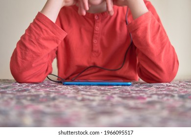 Unrecognizable boy using smart phone. Focus on the phone