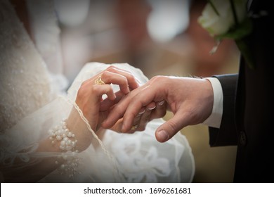 An unrecognizable bride and groom exchanging of the Wedding Rings in church during the christian wedding ceremony  - Shutterstock ID 1696261681