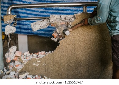 Unrecognizable Builder Using A Sledgehammer Breaking And Smashing The Wall Fallen Into Debris - Breaking Wall And Challenges Concept