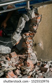 Unrecognizable Builder Using A Sledgehammer Breaking And Smashing The Wall Fallen Into Debris - Breaking Wall And Challenges Concept