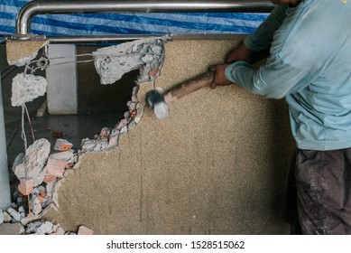 Unrecognizable Builder Using A Sledgehammer Breaking And Smashing The Wall Fallen Into Debris - Breaking Wall And Challenges Concept