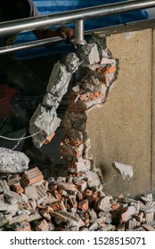 Unrecognizable Builder Using A Sledgehammer Breaking And Smashing The Wall Fallen Into Debris - Breaking Wall And Challenges Concept