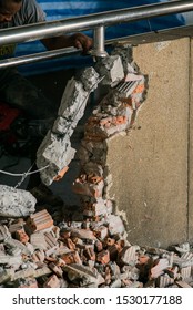 Unrecognizable Builder Using A Sledgehammer Breaking And Smashing The Wall Fallen Into Debris - Breaking Wall And Challenges Concept