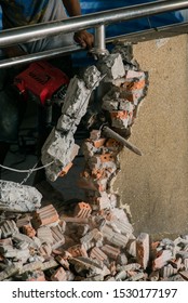 Unrecognizable Builder Using A Sledgehammer Breaking And Smashing The Wall Fallen Into Debris - Breaking Wall And Challenges Concept