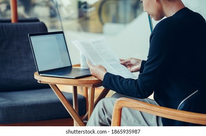 Unrecognizable Business Woman Reading Documents In Caffe