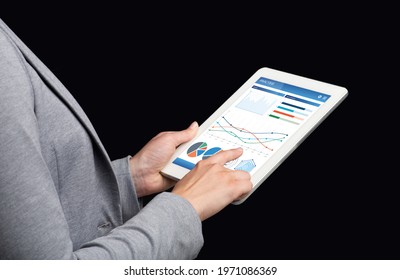 Unrecognizable Business Woman Using Financial App For Market Analysis On Digital Tablet, Black Background, Creative Image. Cropped Of Lady In Suit Analysing Stocks Online, Using Pad