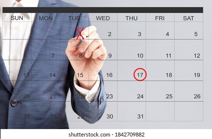 Unrecognizable businessman hand marking dates with red marker on virtual calendar, managing his business schedule, setting reminders for important appointments, creative collage for planning concept