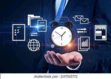 Unrecognizable businessman holding alarm clock with internet documents and schedules. Time management concept. Toned image double exposure