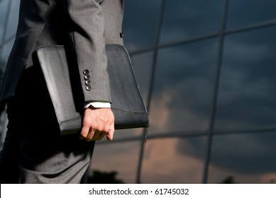 Unrecognizable businessman with suitcase working late concept - Powered by Shutterstock