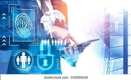 Unrecognizable businessman using tablet computer in modern city with double exposure of futuristic cybersecurity interface. Toned image. Elements of this image furnished by NASA
