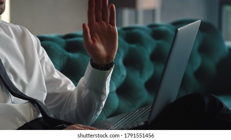 Unrecognizable Businessman Waving Hand On Laptop Camera At Remote Workplace. Unknown Male Worker Having Video Call On Laptop With Green Screen. Closeup Business Man Hands Gesturing During Video Chat