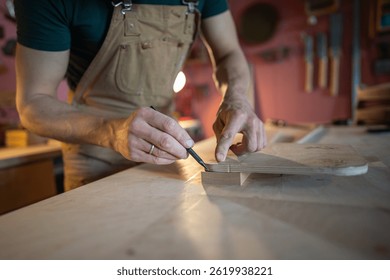 Unrecognizable carpenter hands marking precise angles and screw locations on wooden furniture component. Workshop measurement, assembly prepare, precision in pencil markings, woodworking craftsmanship