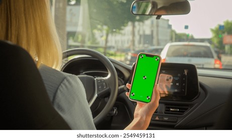 Unrecognizable Caucasian businesswoman girl driving car driver female steering wheel transportation in city auto buyer woman looking mobile phone green screen gps navigator app automobile vehicle rent - Powered by Shutterstock