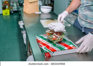 Unrecognizable Chef In The Kitchen With A Food Delivery Order Ready To Go