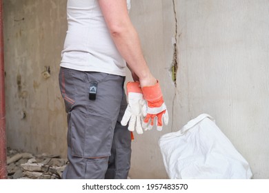 Unrecognizable Construction Worker Putting On Protective Gloves. Safety At Work.