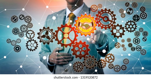 Unrecognizable Corporate Manager Choosing Handshake Icon On A Cog Wheel In Virtual Gear Train. Business Concept For Merger, Agreement, Success, Achievement, Goal, Strategy, Cyberspace, Engineering.