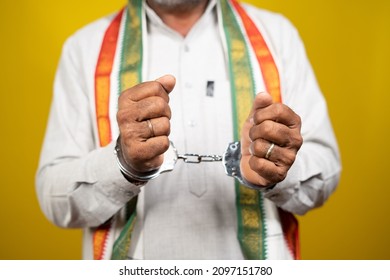 Unrecognizable Criminal Indian Politician With Hand Cuffs Looking On Yellow Background - Concept Of Political Crime, Arrested Political Leader And Trapped In Politics.