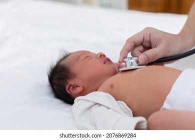 Unrecognizable Doctor Heart Check Up And Diagnosis Baby Newborn With Stethoscope In Clinic Or Hospital.Examining Heartbeat Of Infant With Stethoscope On Chest Sick Baby.Baby Health Care Concept