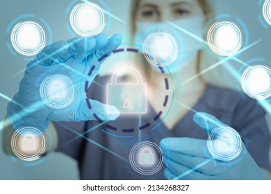 Unrecognizable doctor of medicine securing patient medical records across multiple devices via a computer network. Healthcare IT concept for security of health information exchange and data privacy. - Shutterstock ID 2134268327