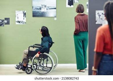 Unrecognizable Ethnically Diverse Young People Looking At Black And White Pictures On Walls At Contemporary Photography Exhibition In University